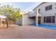 Open backyard with desert landscaping, covered patio area, and second story balcony at 7304 E Northridge Cir, Mesa, AZ 85207