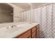 Bright bathroom featuring a double sink vanity, large mirror, and shower with patterned curtain at 7304 E Northridge Cir, Mesa, AZ 85207