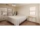 Bright bedroom with a large window, neutral carpet, ceiling fan, and comfortable bed at 7304 E Northridge Cir, Mesa, AZ 85207