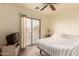 Bright bedroom with a sliding glass door to the balcony, ceiling fan, and neutral carpet at 7304 E Northridge Cir, Mesa, AZ 85207