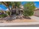 Charming home exterior featuring desert landscaping, mature trees, and inviting entrance at 7304 E Northridge Cir, Mesa, AZ 85207