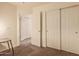 Hallway featuring a door to another room and a closet with sliding doors at 7304 E Northridge Cir, Mesa, AZ 85207
