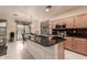 Spacious kitchen island with granite countertop, tile flooring, and sliding glass door to the outdoor space at 7304 E Northridge Cir, Mesa, AZ 85207
