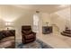 Inviting living room featuring a leather recliner, arched entryway, and tile floors with a decorative rug at 7304 E Northridge Cir, Mesa, AZ 85207