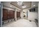 Locker room area with dark wood cabinets, benches, and tile flooring at 7304 E Northridge Cir, Mesa, AZ 85207