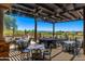 Covered patio dining area offering beautiful views of the desert landscape and golf course at 7304 E Northridge Cir, Mesa, AZ 85207