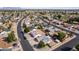A high angle shot of the home showcases its location within a community with lush green spaces and nearby lakes at 7309 E Diamond Ave, Mesa, AZ 85208