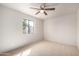 Well-lit bedroom with neutral carpet and a window overlooking the backyard at 7309 E Diamond Ave, Mesa, AZ 85208
