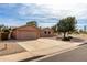 Charming single-story home with a spacious driveway, two-car garage, and low-maintenance landscaping at 7309 E Diamond Ave, Mesa, AZ 85208