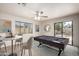 Bright game room features a billiard table, adjacent seating, and sliding glass door at 7309 E Diamond Ave, Mesa, AZ 85208