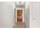 Hallway view with a wood door and neutral wall paint at 7309 E Diamond Ave, Mesa, AZ 85208