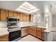 Kitchen features modern appliances, wood cabinets, and a pass-through to the dining area at 7309 E Diamond Ave, Mesa, AZ 85208