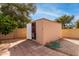 Backyard storage shed with shelving and a concrete paver pad at 7309 E Diamond Ave, Mesa, AZ 85208