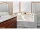 Bright bathroom featuring a soaking tub, privacy window, a double vanity and neutral decor at 741 W Harvard Ave, Gilbert, AZ 85233
