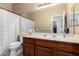 Traditional bathroom featuring a single sink vanity and a shower-tub combination at 741 W Harvard Ave, Gilbert, AZ 85233