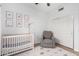 Calm Bedroom featuring a crib, cozy gray armchair, and cute celestial-themed decorations at 741 W Harvard Ave, Gilbert, AZ 85233