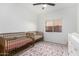 Bedroom featuring two baby beds, a floral rug, and natural light from a window at 741 W Harvard Ave, Gilbert, AZ 85233