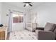 Bright Bedroom with neutral tones, a crib, a comfortable glider, and decorative wall art at 741 W Harvard Ave, Gilbert, AZ 85233
