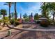 Entrance to the Silverhawke community, featuring lush palm trees, native plants, and flag display at 741 W Harvard Ave, Gilbert, AZ 85233
