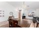 Bright dining area with wood flooring, decorative lighting fixture, and entry view at 741 W Harvard Ave, Gilbert, AZ 85233