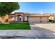 Single-story home featuring desert landscaping, a tile roof, and a three-car garage at 741 W Harvard Ave, Gilbert, AZ 85233