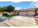 Single-story home featuring desert landscaping, a tile roof, and a three-car garage with extended driveway at 741 W Harvard Ave, Gilbert, AZ 85233