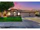 Beautiful single-story home featuring a tile roof, arched entryway, and a well-manicured front lawn at 741 W Harvard Ave, Gilbert, AZ 85233