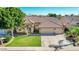 Beautiful single-story home with desert landscaping, arched entry, and a spacious driveway leading to the attached garage at 741 W Harvard Ave, Gilbert, AZ 85233