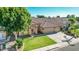 Well-kept home with green lawn, mature shade tree, a two-car garage, and desert landscaping in a quiet neighborhood at 741 W Harvard Ave, Gilbert, AZ 85233