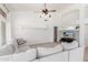 Bright living room features vaulted ceiling, ceiling fan, white sofa, and natural lighting at 741 W Harvard Ave, Gilbert, AZ 85233