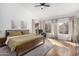 Spacious main bedroom featuring neutral tones, ensuite bathroom, a ceiling fan and lots of natural light at 741 W Harvard Ave, Gilbert, AZ 85233