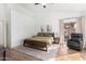 Bright main bedroom with a lounge chair, carpet and natural light from the sliding glass doors and multiple windows at 741 W Harvard Ave, Gilbert, AZ 85233