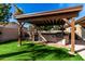 View of the covered outdoor kitchen and barbeque area, set amidst a well-maintained lawn at 741 W Harvard Ave, Gilbert, AZ 85233