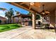 Spacious covered patio with outdoor kitchen, BBQ grill, and dining area overlooking the backyard at 741 W Harvard Ave, Gilbert, AZ 85233