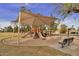 Shaded community playground with slides, climbing features, and a comfortable seating area for parents and children at 741 W Harvard Ave, Gilbert, AZ 85233
