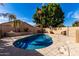 Backyard view of the private swimming pool, framed by stone decking, landscaping and privacy walls at 741 W Harvard Ave, Gilbert, AZ 85233