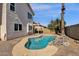 Backyard view with a kidney-shaped pool and patio area with desert landscaping at 811 N Los Feliz Dr, Chandler, AZ 85226
