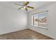 Neutral bedroom with a ceiling fan and a window bringing in natural light at 811 N Los Feliz Dr, Chandler, AZ 85226