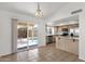 Open dining area featuring tile floors, a sliding glass door to the backyard, and a view of the kitchen at 811 N Los Feliz Dr, Chandler, AZ 85226