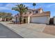 Spacious home with a two-car garage, terracotta tile roof, desert landscaping, and a mature palm tree in the front yard at 811 N Los Feliz Dr, Chandler, AZ 85226