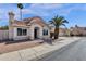 Inviting single-Gathering home featuring a terracotta tile roof, desert landscaping, and a mature palm tree in the front yard at 811 N Los Feliz Dr, Chandler, AZ 85226