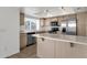Bright kitchen featuring wooden cabinets, stainless steel appliances, and a convenient island at 811 N Los Feliz Dr, Chandler, AZ 85226