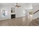 Open living room featuring tile floors, a fireplace, staircase, and a sliding glass door leading to the backyard at 811 N Los Feliz Dr, Chandler, AZ 85226