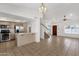 Open-concept living area with tiled floors, ceiling fans and lots of natural light, seamlessly connected to the kitchen and staircase at 811 N Los Feliz Dr, Chandler, AZ 85226