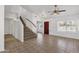 Bright living room featuring tile floors, staircase, a ceiling fan, and a view of the entryway at 811 N Los Feliz Dr, Chandler, AZ 85226