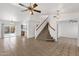 Spacious living room with tile floors, a staircase, and a view of the kitchen and backyard pool at 811 N Los Feliz Dr, Chandler, AZ 85226