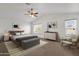 Well-lit main bedroom featuring a ceiling fan and ample natural light from two windows at 811 N Los Feliz Dr, Chandler, AZ 85226