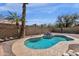Inviting kidney-shaped pool features decorative rock waterfall and lush landscaping at 811 N Los Feliz Dr, Chandler, AZ 85226
