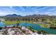 Scenic aerial view of property nestled among lush golf course with lake and mountain backdrop at 8138 E Via De La Escuela --, Scottsdale, AZ 85258