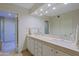 Bathroom with double sinks, granite countertops, and a glass door shower at 8138 E Via De La Escuela --, Scottsdale, AZ 85258